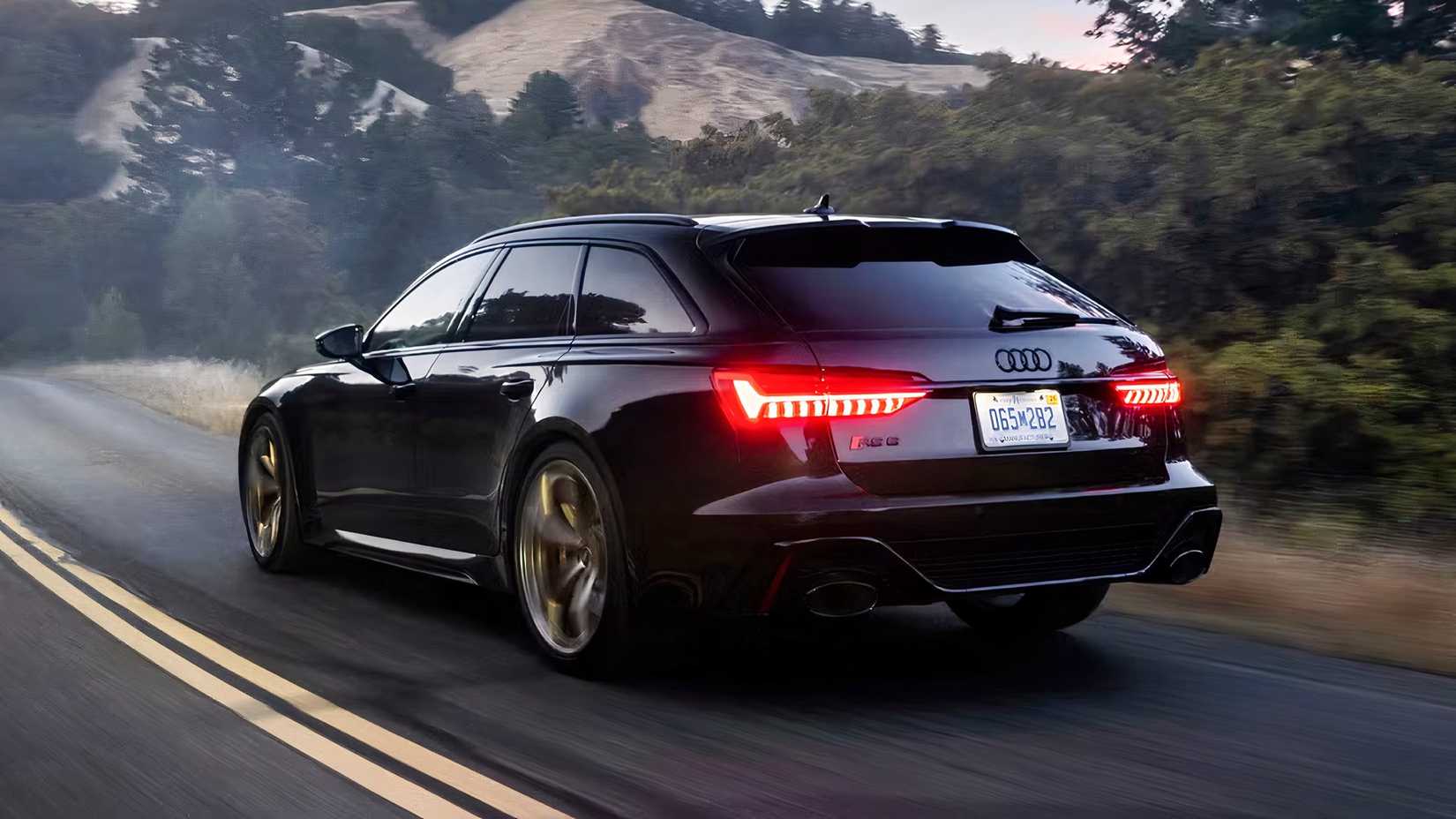 Rear 3/4 action shot of 2026 Audi RS6 Avant Performance driving on road