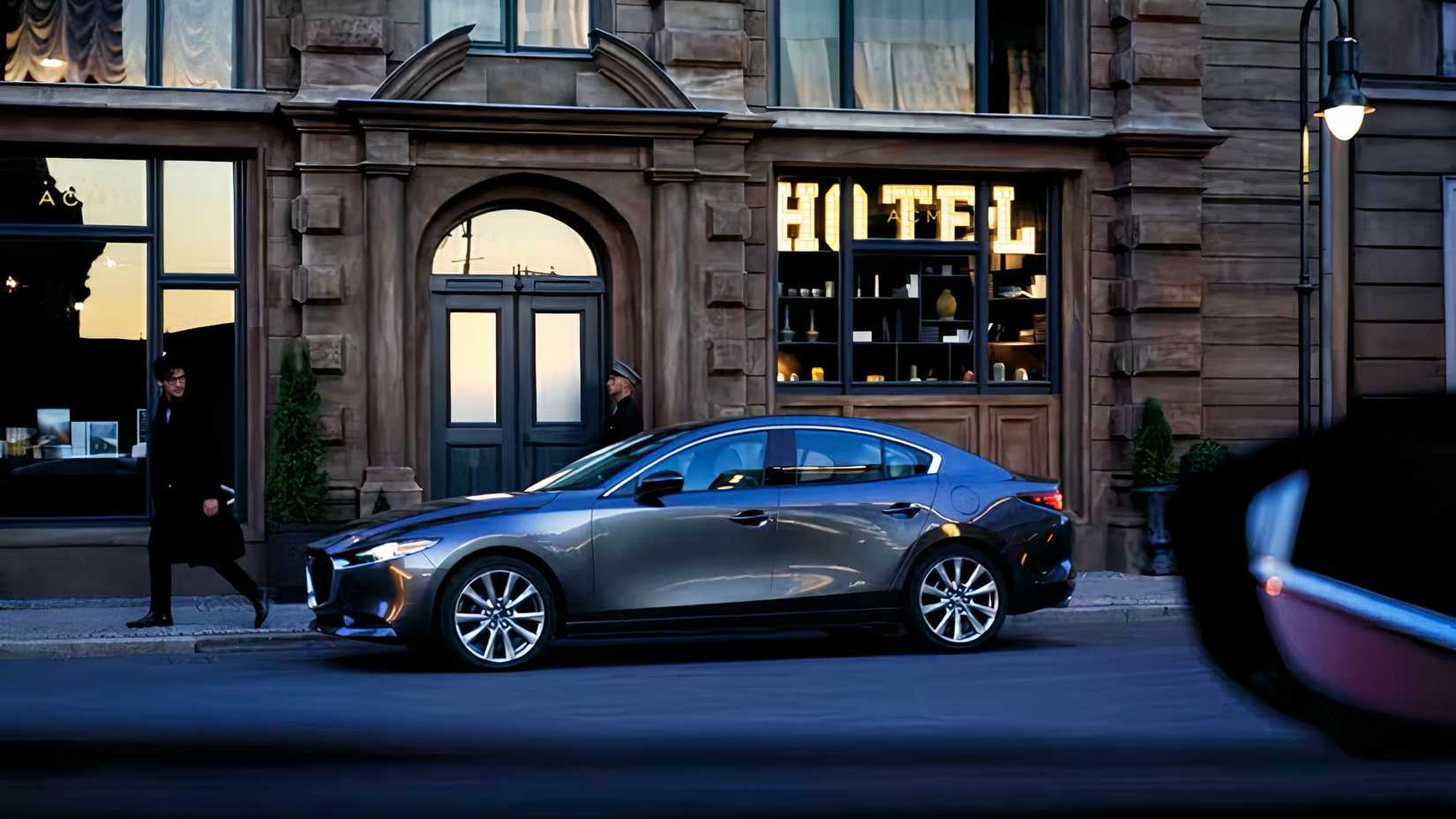 Profile shot of 2026 Mazda 3 Sedan parked on street