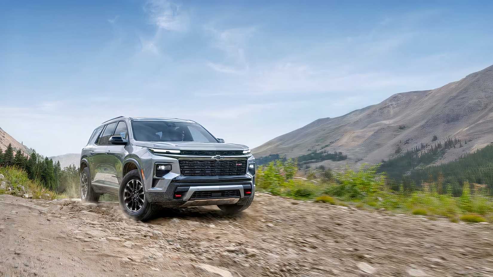 Front 3/4 action shot of 2026 Chevrolet Traverse driving off-road