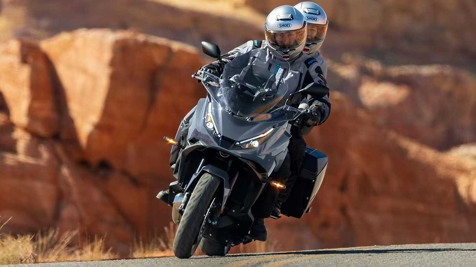 2026 Honda NT1100 DCT on the highway with rider and pillion front fascia view
