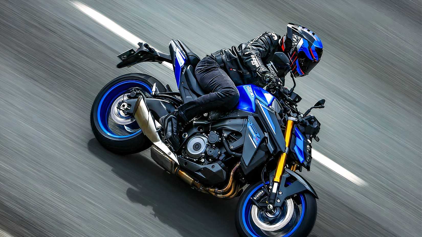 Rider cornering hard on a Suzuki GSX-S1000