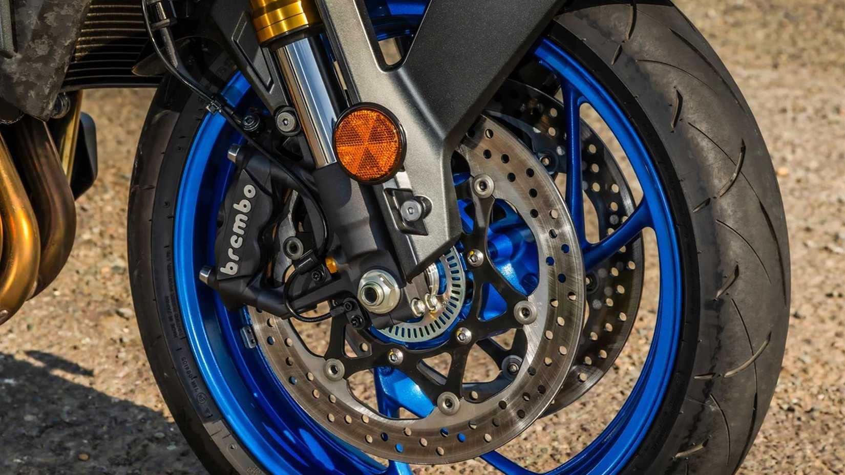Close up shot of a Suzuki GSX-S1000's front tyre and brakes