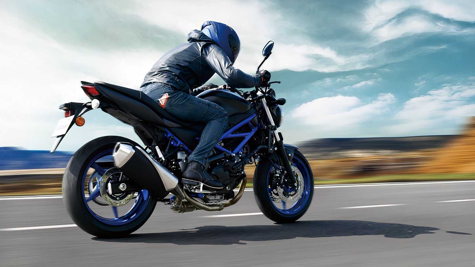 Suzuki SV650 rider racing on the highway