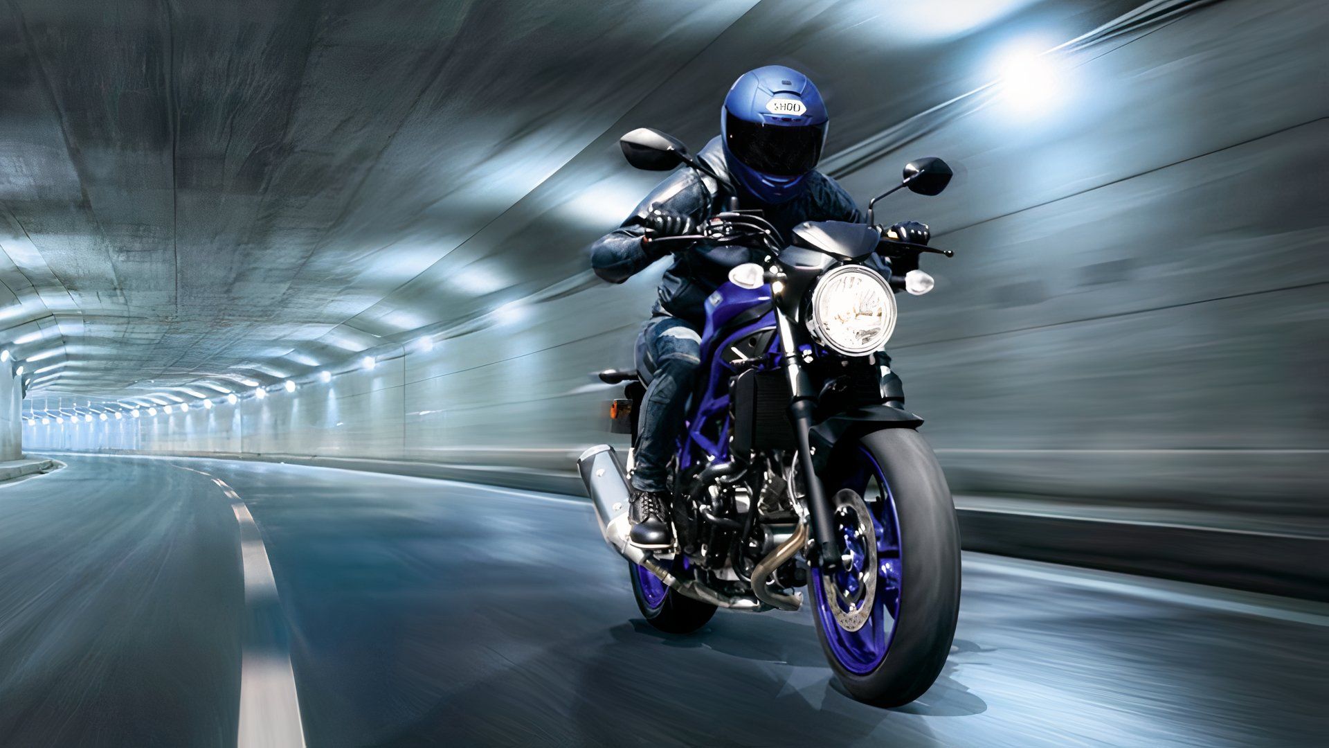 A rider on a Suzuki SV650 in a tunnel