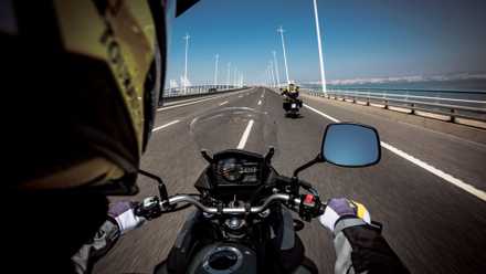 POV of a passenger on a Suzuki V-Strom 650XT traveling on the highway