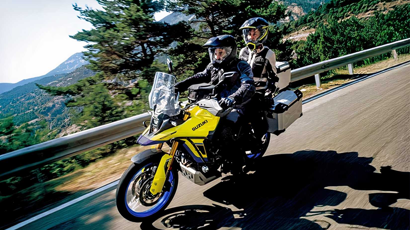 Tracking shot of a Suzuki V-Strom 800DE being ridden two-up