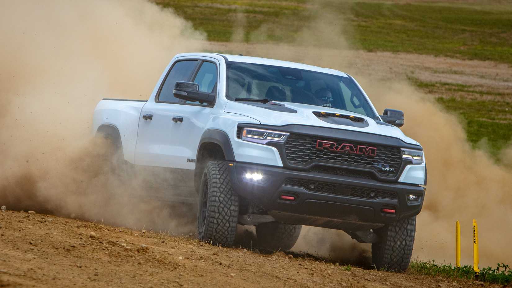 Front 3/4 action shot of 2027 Ram 1500 TRX driving off-road