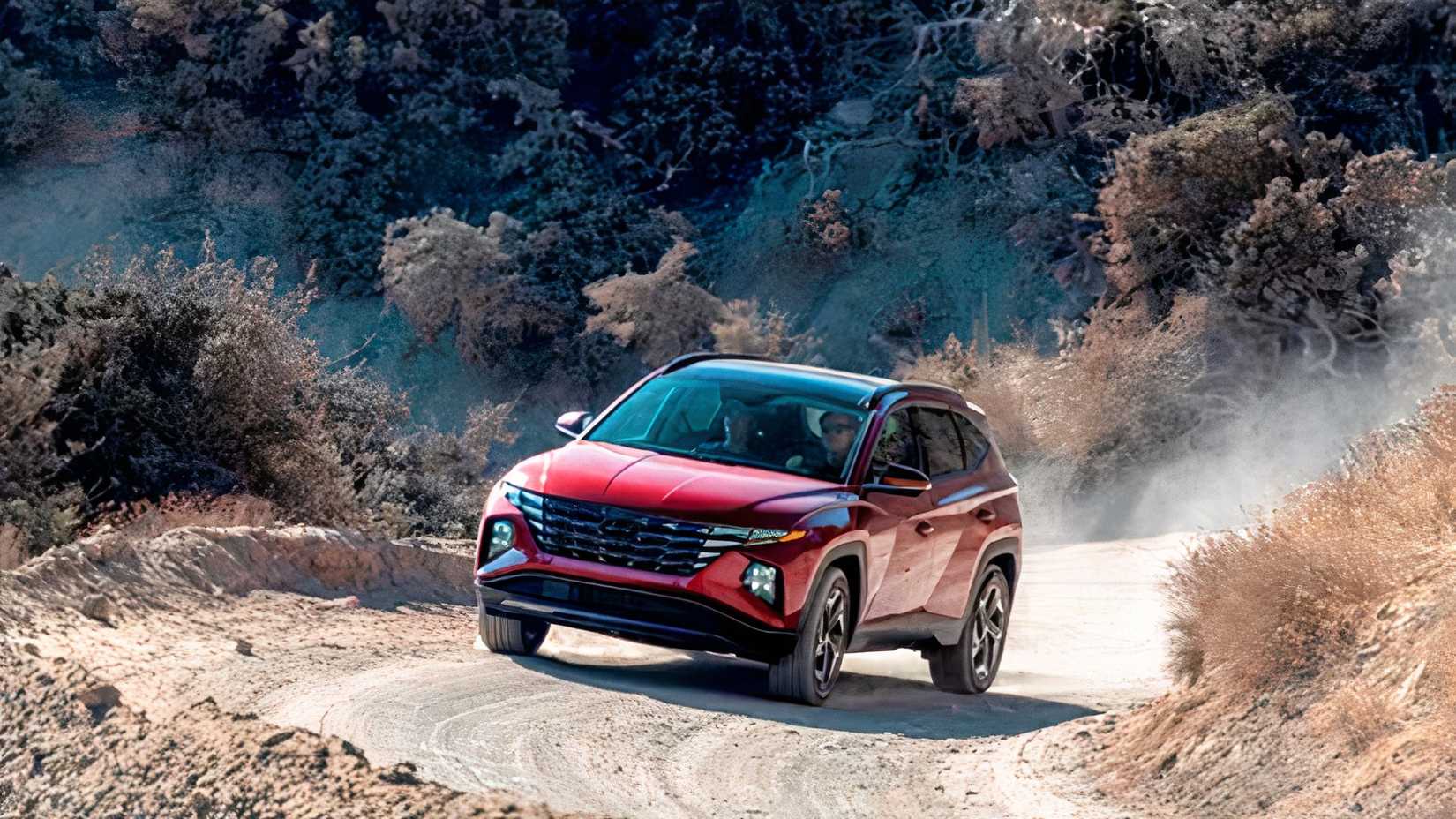 Front 3/4 action shot of 2023 Hyundai Tucson Hybrid driving off-road