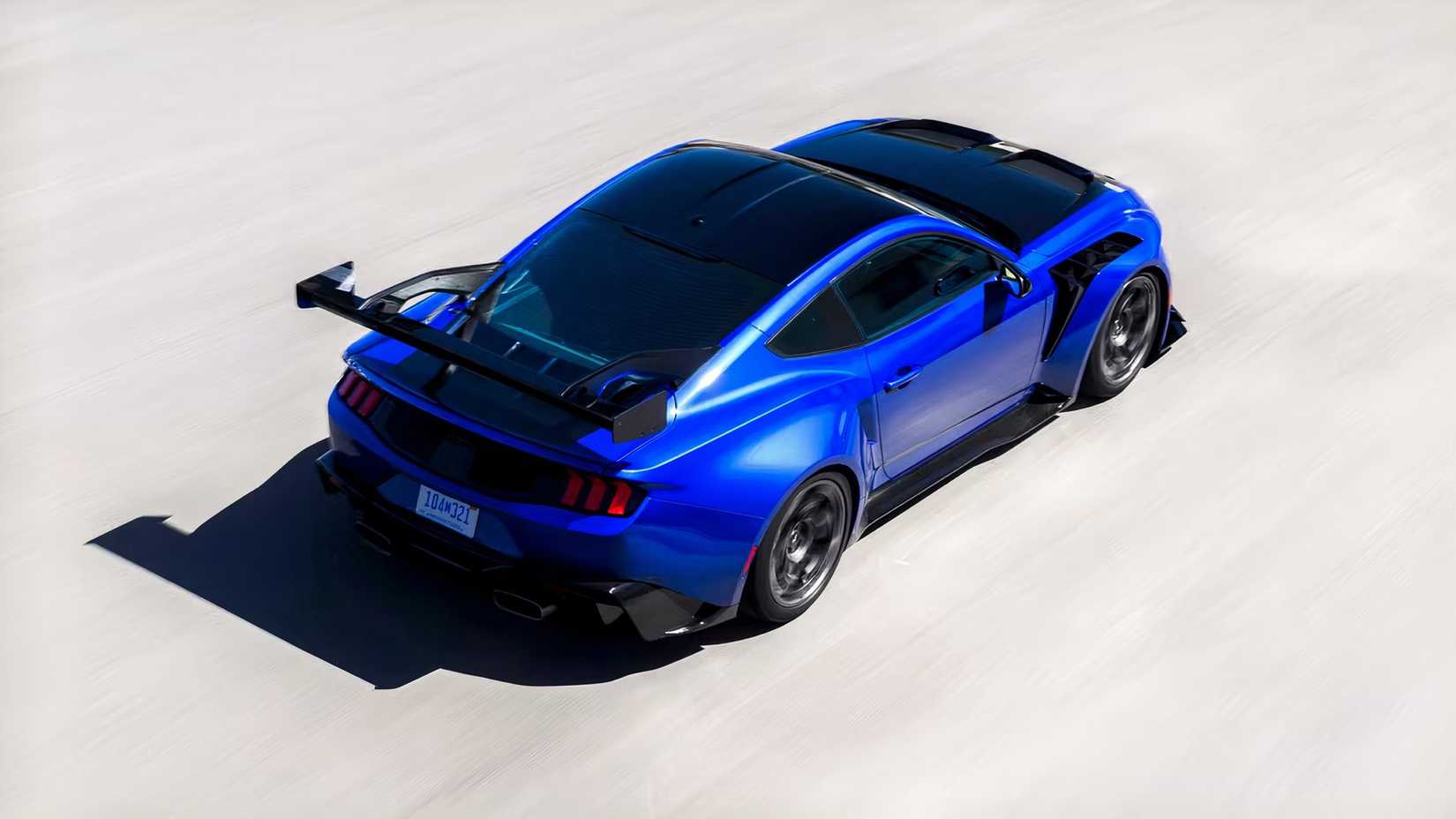 Rear 3/4 action shot of the 2026 Ford Mustang GTD driving on the track