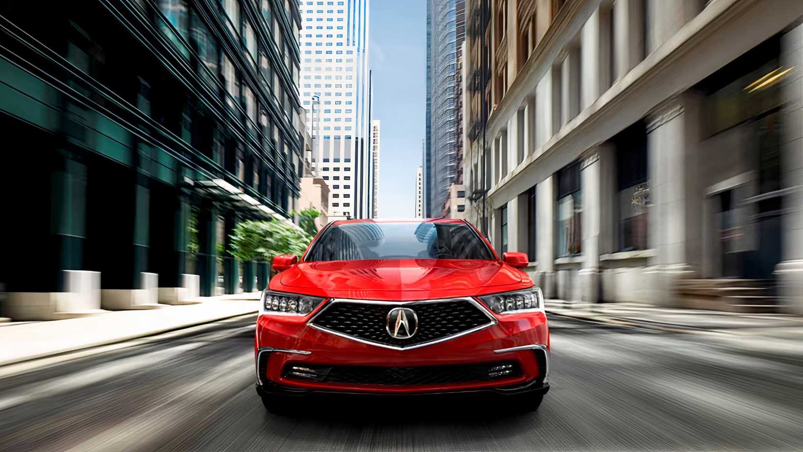 Front action shot of 2020 Acura RLX Sport driving on road