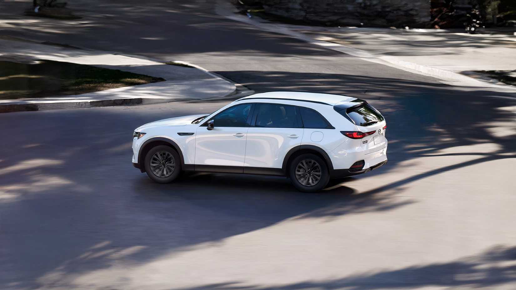 Rear 3/4 action shot of 2026 Mazda CX-70 PHEV driving on road