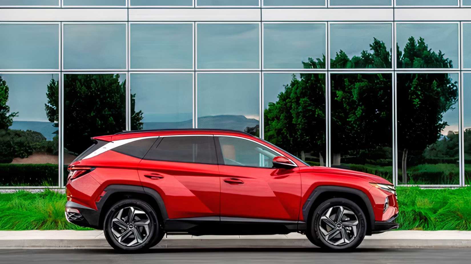 Profile action shot of 2023 Hyundai Tucson Hybrid driving on road