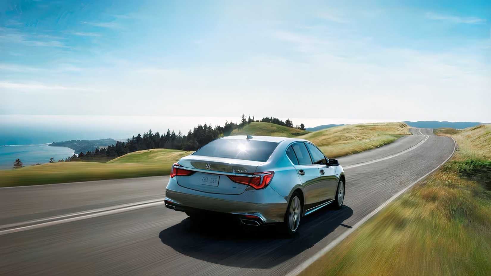 Rear 3/4 action shot of 2020 Acura RLX driving on road