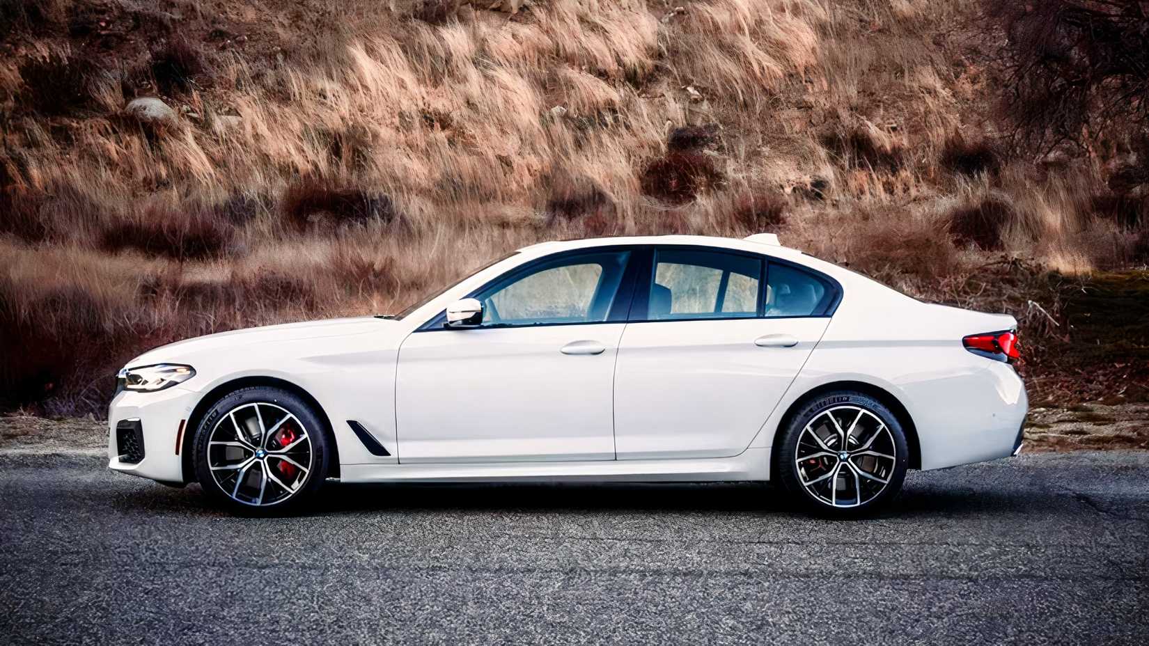 Profile shot of 2021 BMW 5 Series sedan parked on road