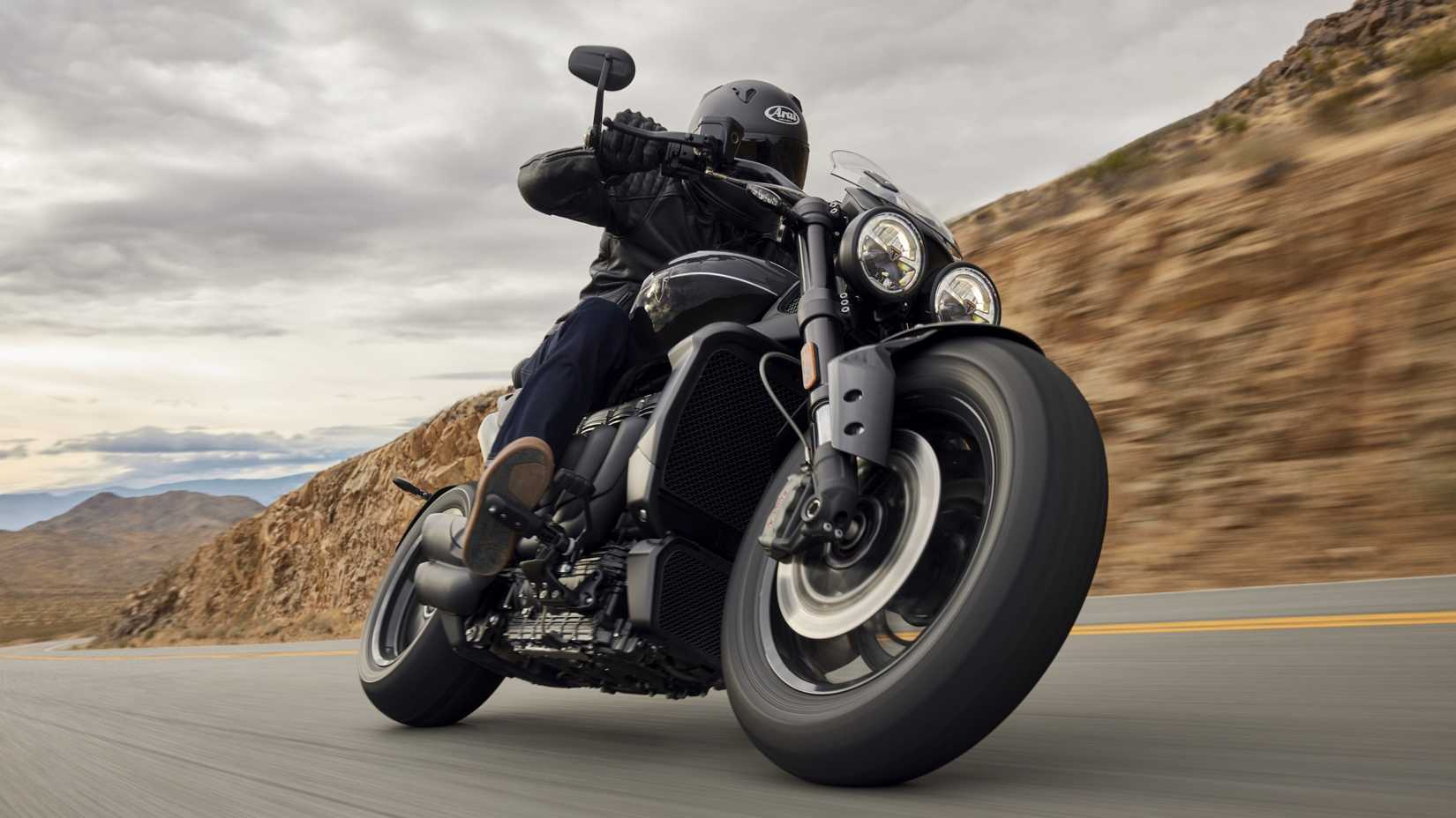 Triumph Rocket 3 GT Storm accelerating hard through a corner front third quarter cinematic shot
