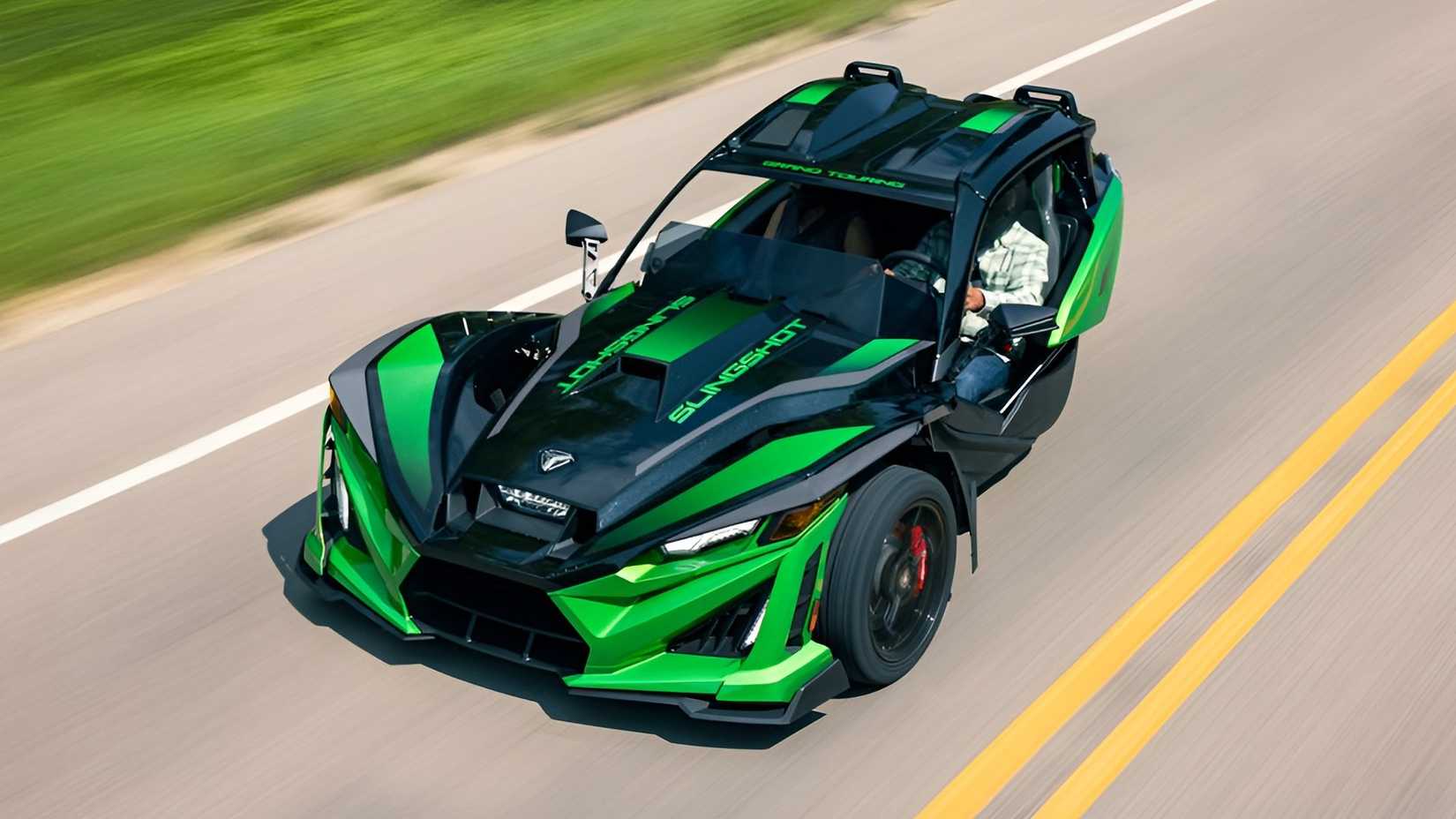 Polaris Slingshot Grand Touring accelerating on the road front third quarter ariel view