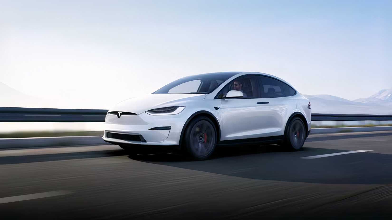 Front 3/4 action shot of 2026 Tesla Model X driving on road