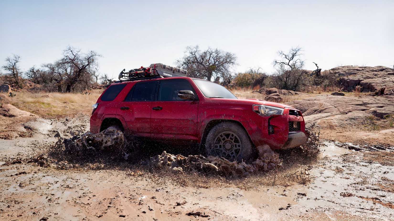Side shot of a 2022 Toyota 4Runner Plowing Through Mud