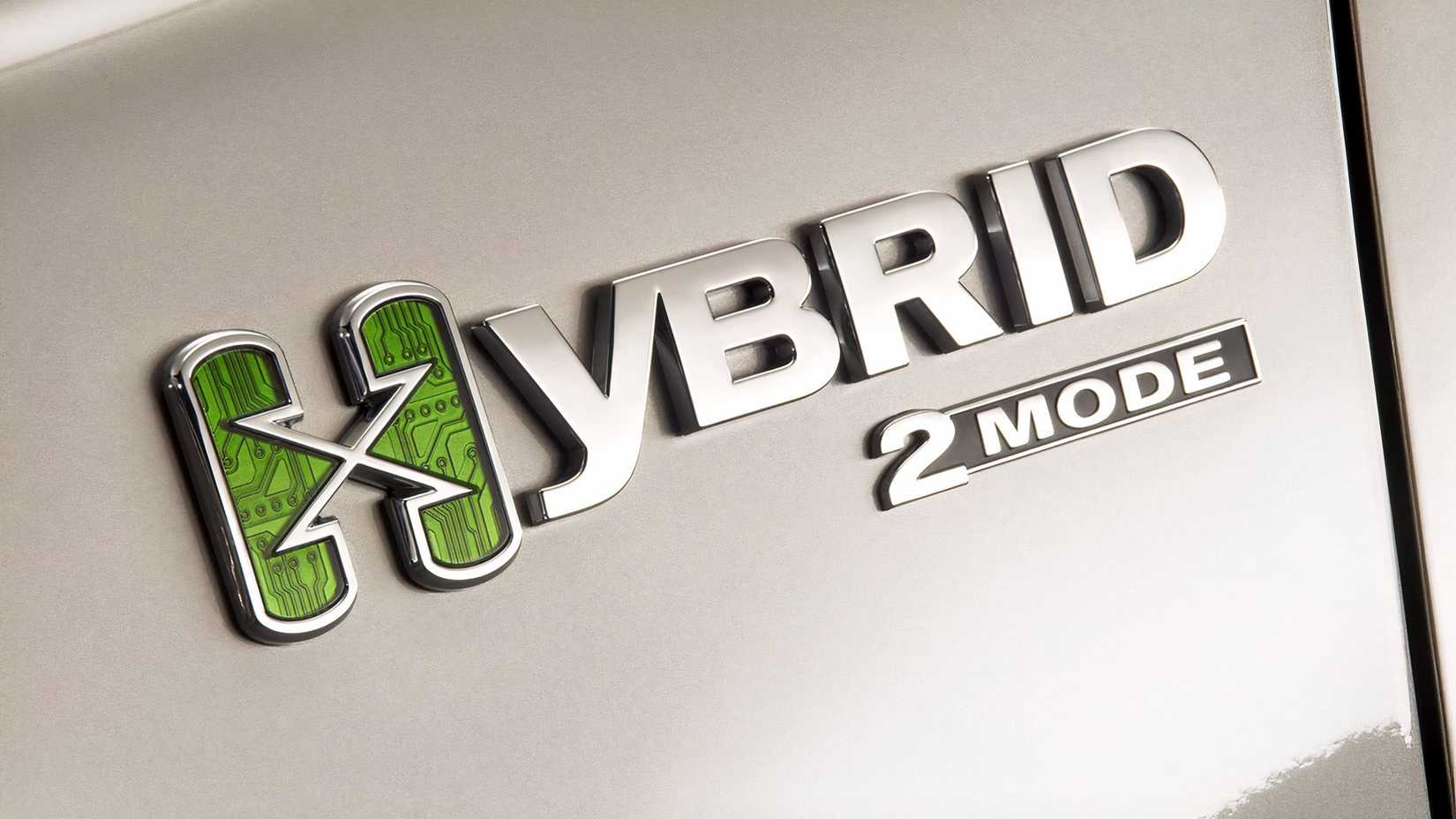 Detail shot of a taupe 2009 GMC Sierra Hybrid Crew Cab showing the hybrid logo on the front fender