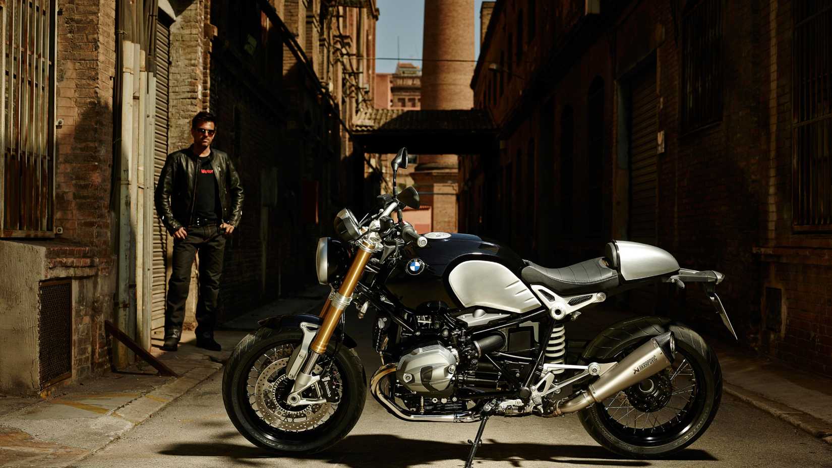 Static hero shot of 2014 BMW R nineT with the rider overlooking