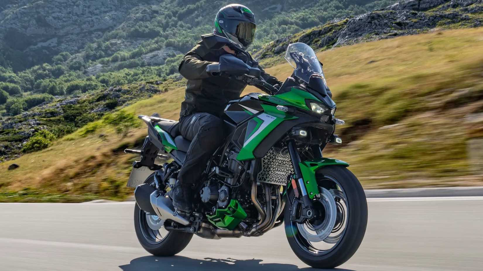 2027 Kawasaki Versys 900 accelerating along a mountain road