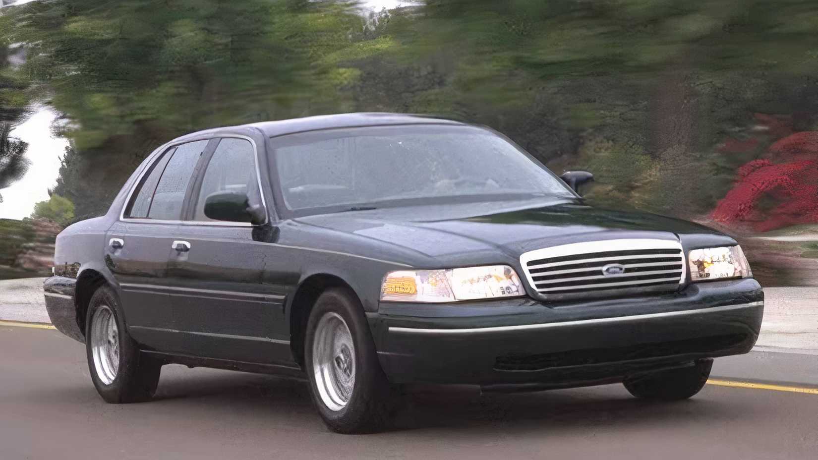 Front 3/4 action shot of 2000 Ford Crown Victoria driving on road