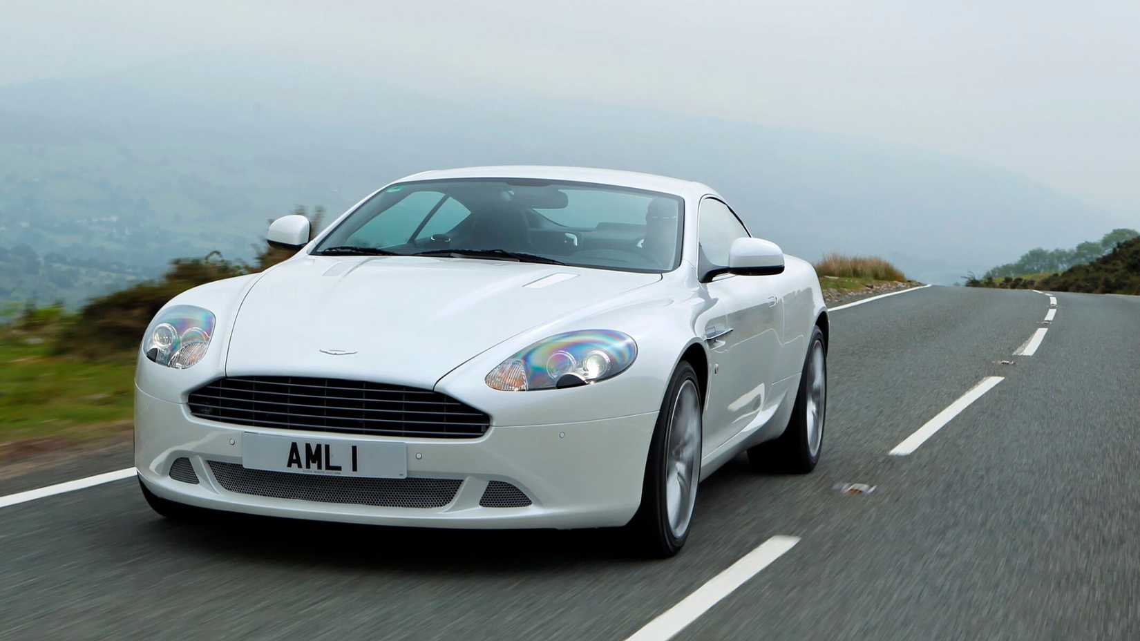 A front angle shot of a 2005-2012 Aston Martin DB9 Coupe driving