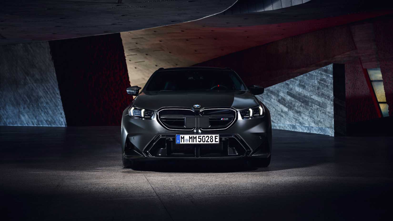 2025 BMW M5 Touring in black parked inside