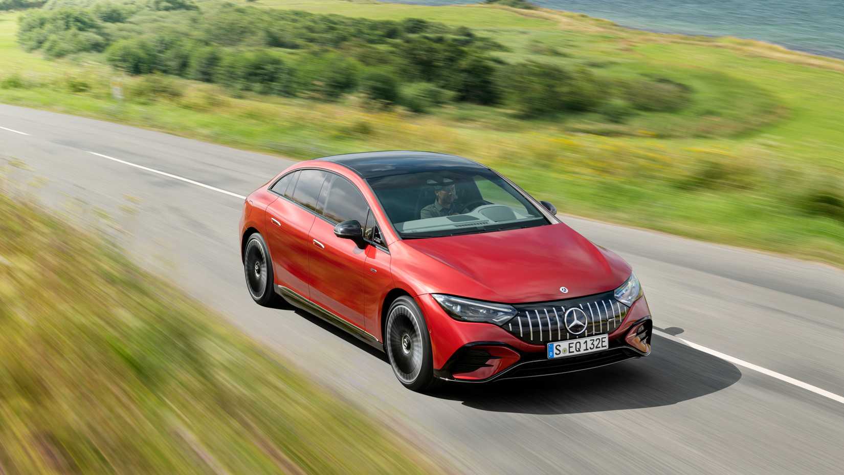 Mercedes-AMG EQE in red accelerating front third quarter view