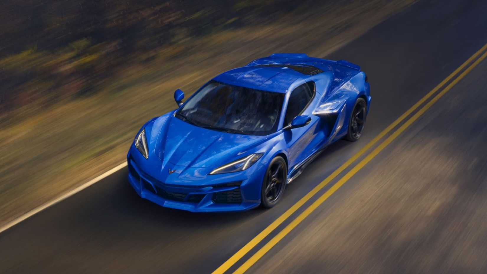 Front 3/4 action shot of 2026 Chevrolet Corvette E-Ray driving on road
