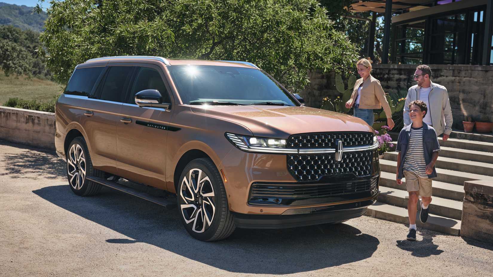 A family approaching the 2025 Lincoln Navigator Black Label