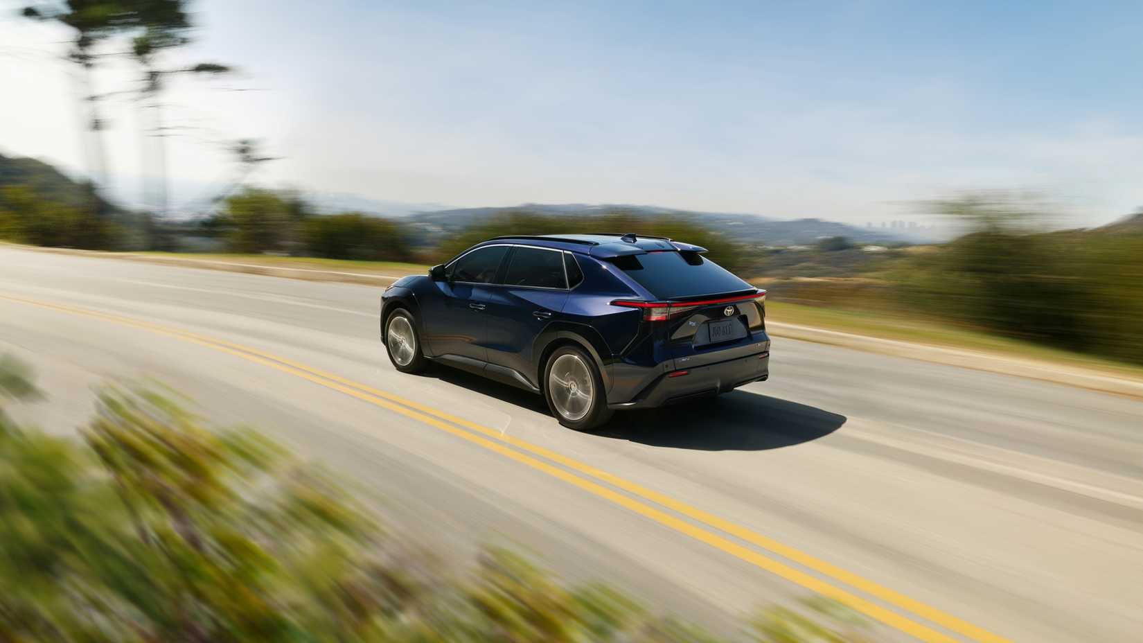 A 2026 Toyota bZ speeding down a mountain road