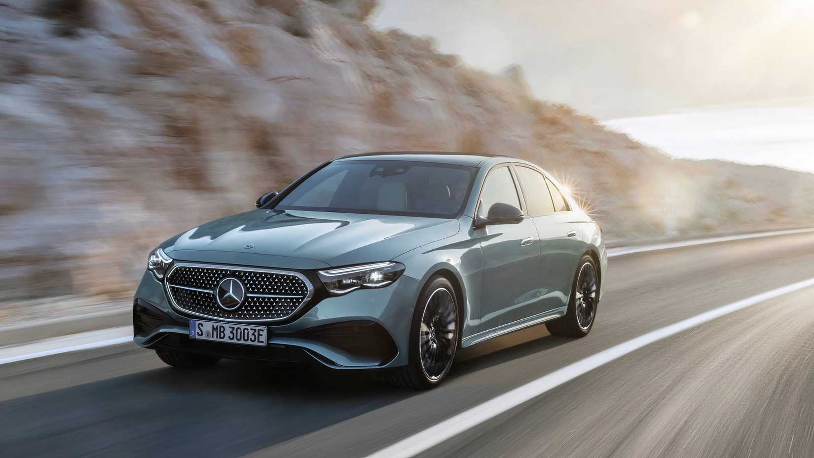 Front 3/4 action shot of 2026 Mercedes-Benz E-Class sedan driving on road