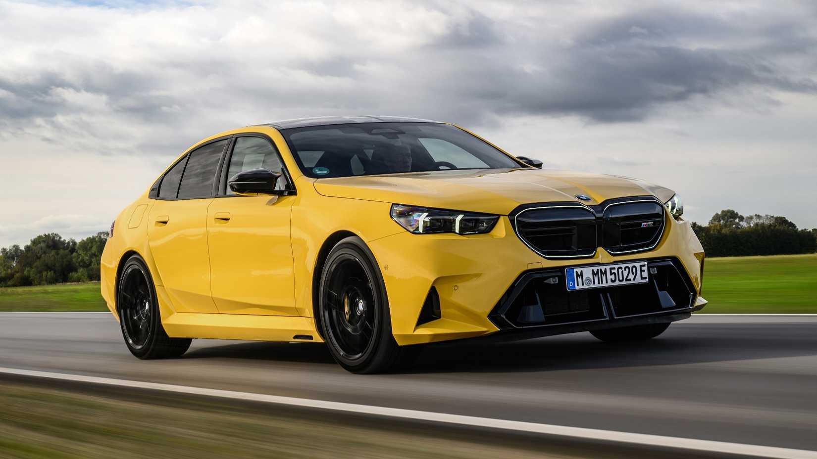 Front shot of a 2025 BMW M5 Sedan driving on the road