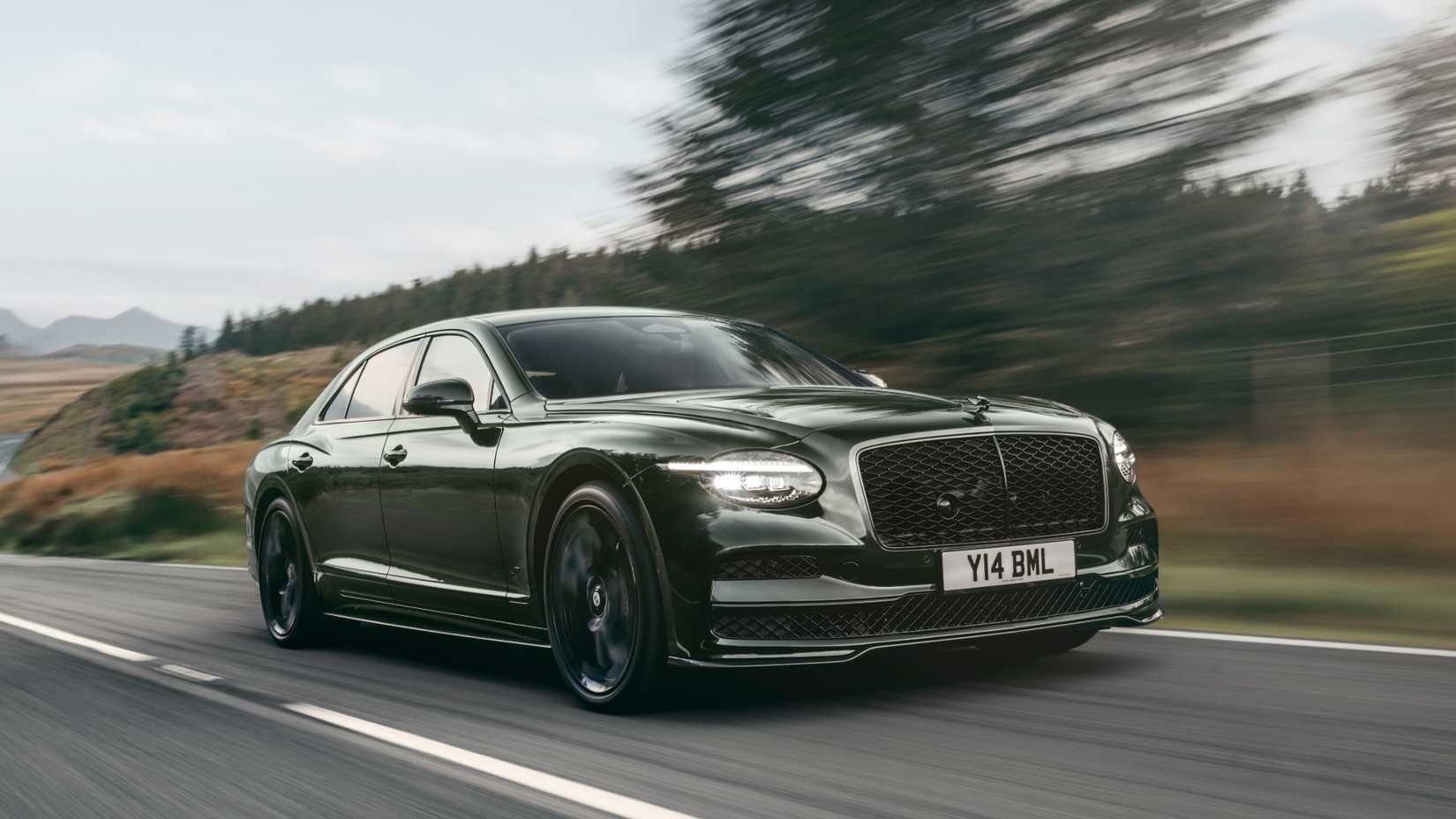 Front 3/4 action shot of 2027 Bentley Flying Spur driving on road