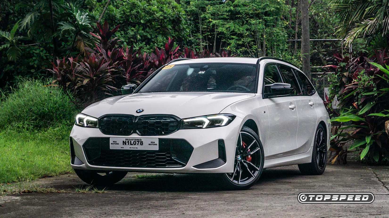 Front 3/4 view of a 2023 BMW M340i xDrive Touring