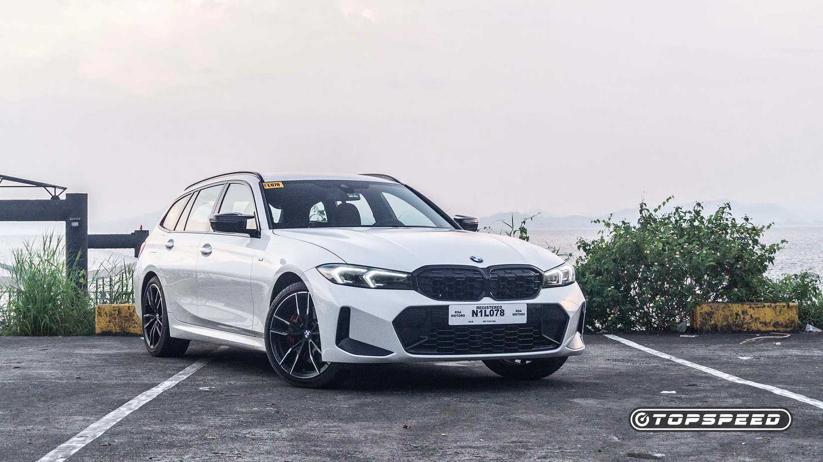 Front 3/4 view of a 2023 BMW M340i xDrive Touring