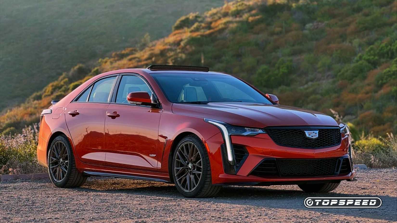 2023 orange Cadillac CT4-V Blackwing parked in front of hills