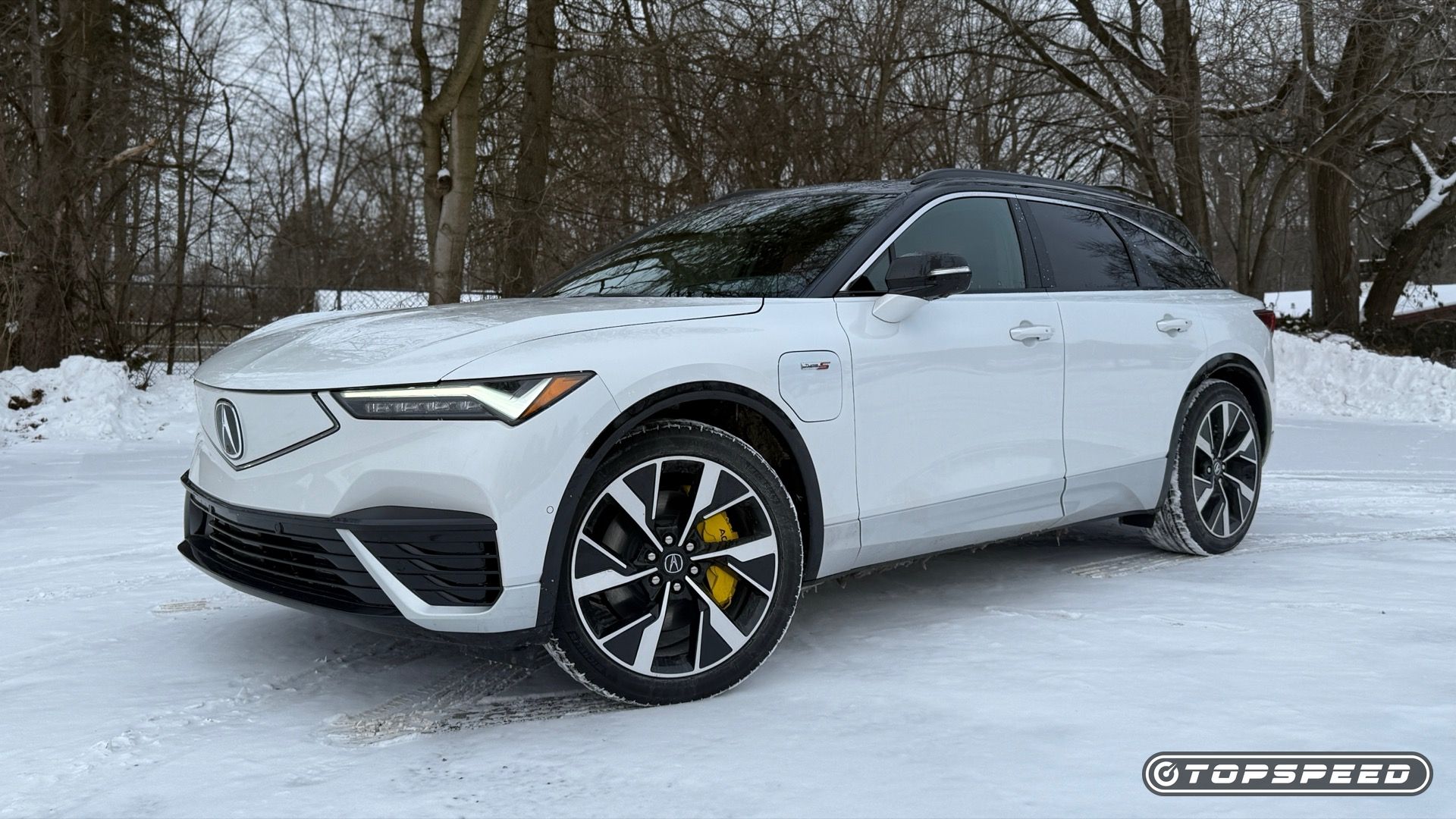 Static front three-quarters photo of a white 2025 Acura ZDX Type S in the snow