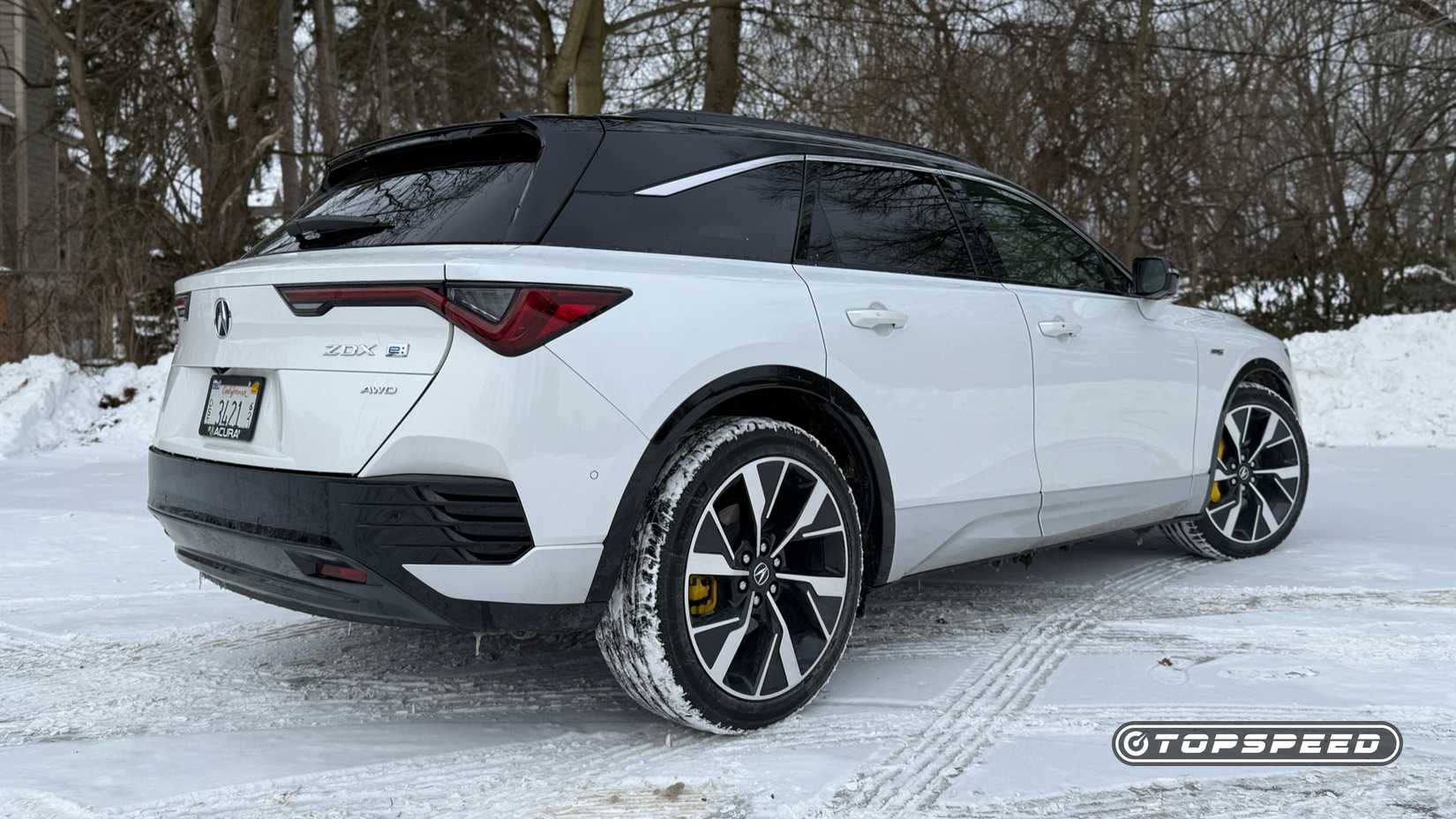 Static rear three-quarters photo of a 2025 Acura ZDX Type S parked in the snow