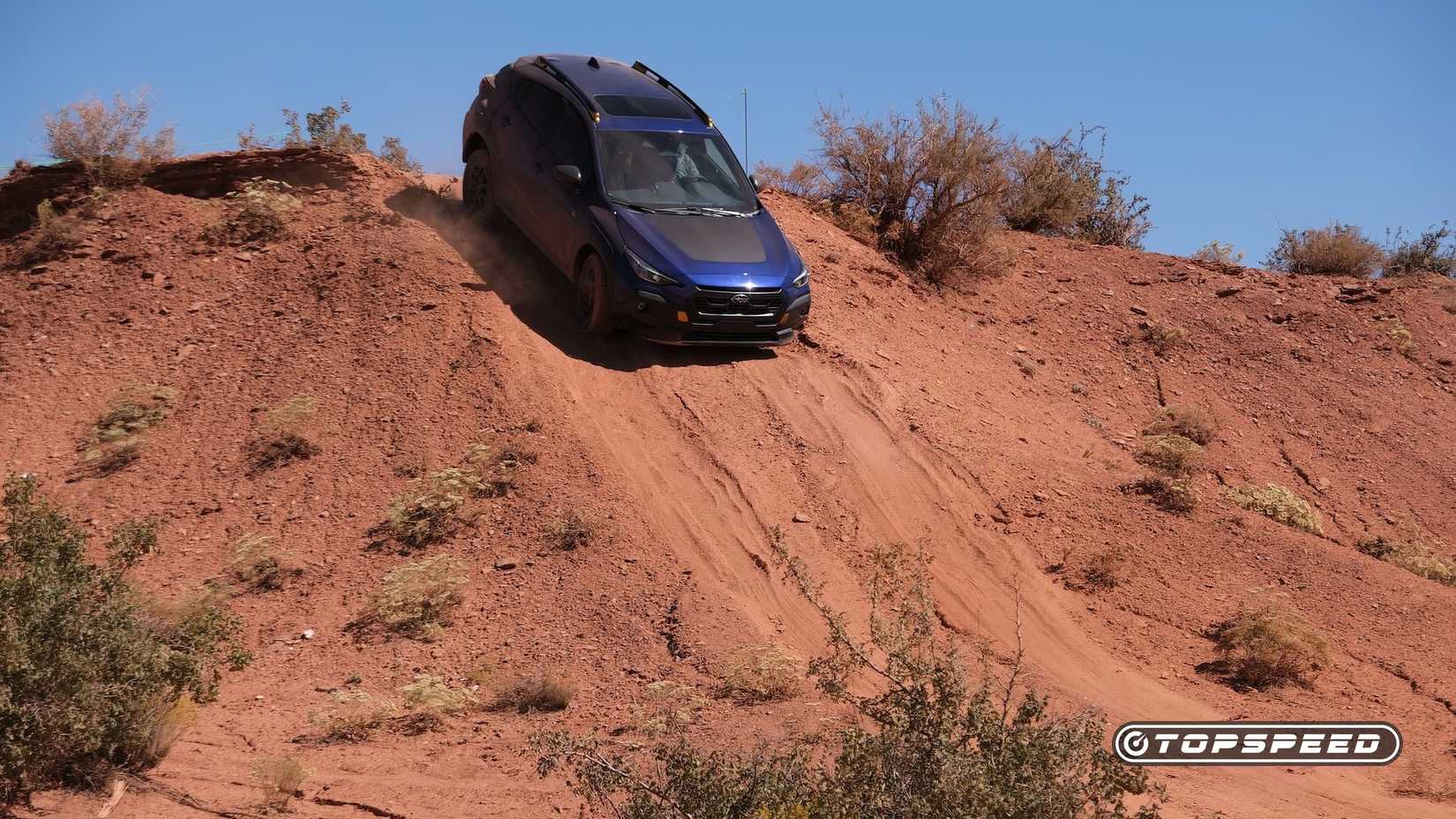 Front shot of a 2025 Subaru Crosstrek Wilderness driving off-road