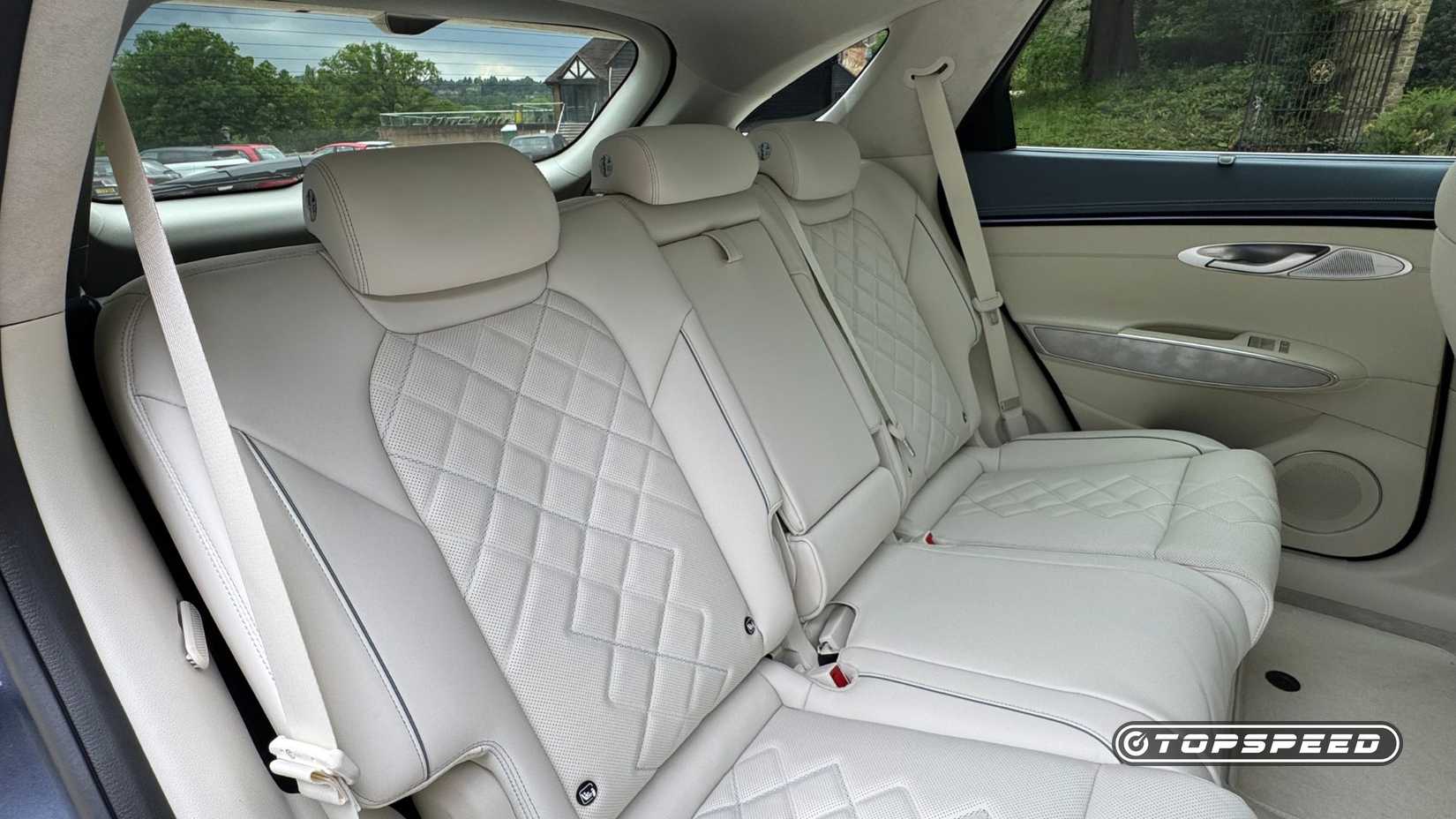 Close-up shot of the rear seats finished in cream leather in a 2026 Genesis Electrified GV70.