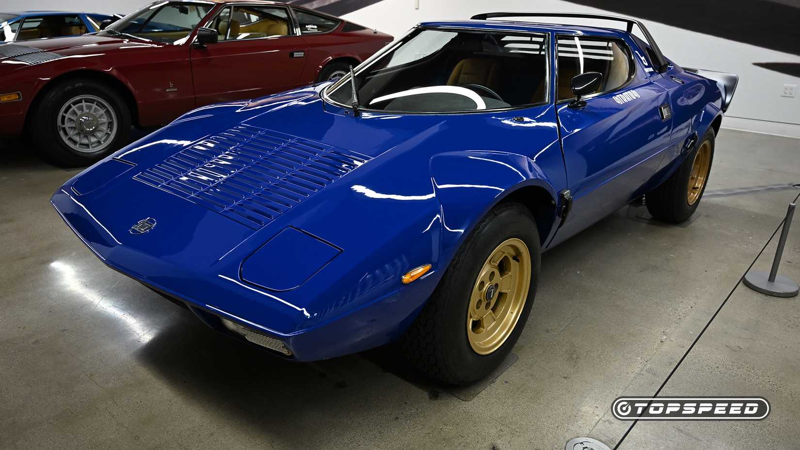 Front 3/4 shot of a blue Lancia Stratos parked in building
