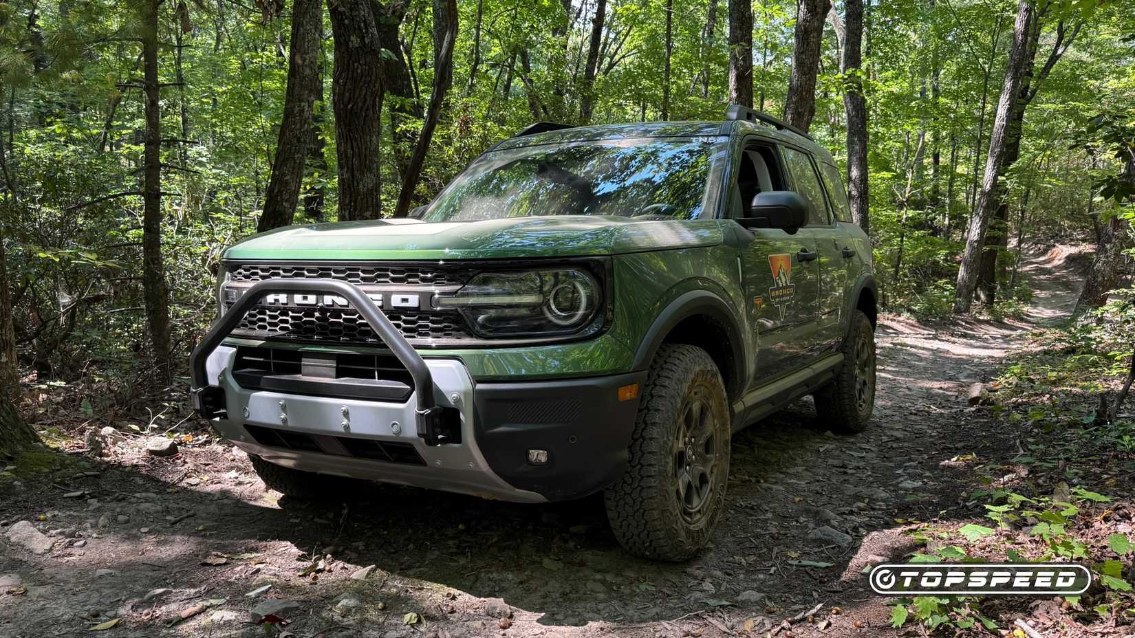 2025 Ford Bronco Sport Badlands with Sasquatch Package front three-quarters in green on trail