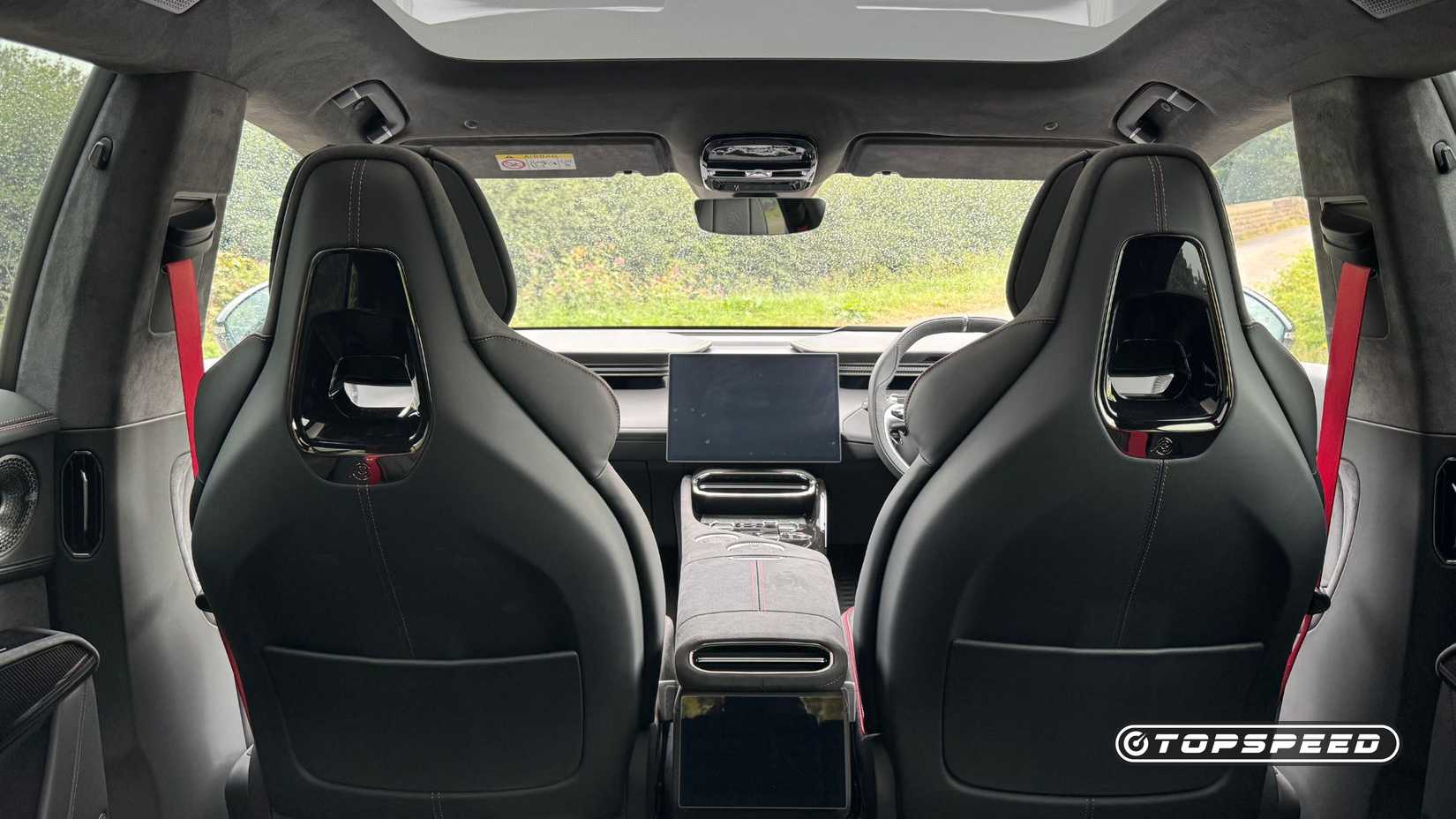Shot inside the cabin of a 2025 Lotus Eletre 600 Sport SE showing the back of the front seats and infotainment screen.