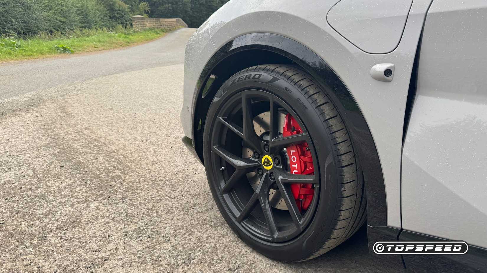 Close-up shot of the black alloy wheel on a gray 2025 Lotus Eletre 600 Sport SE.