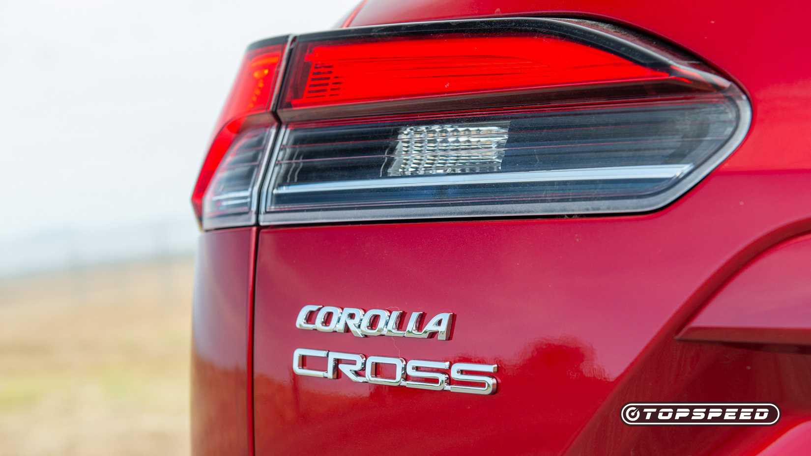 Red 2026 Toyota Corolla Cross rear badge close-up shot