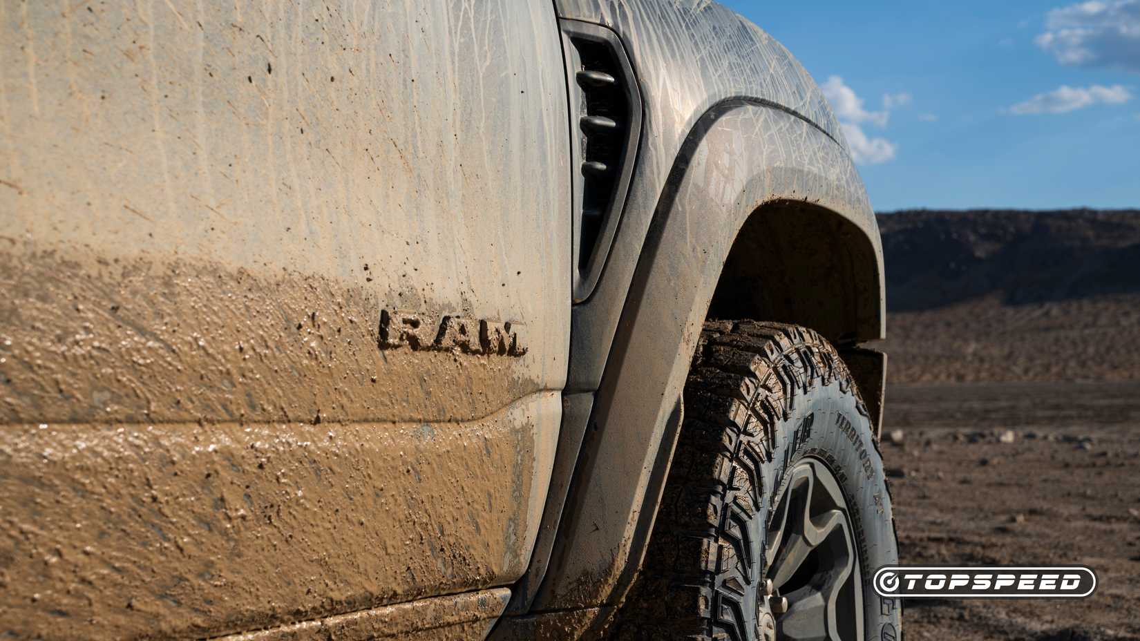 A close-up shot of the Ram logo on the 2025 blue Ram 1500 RHO