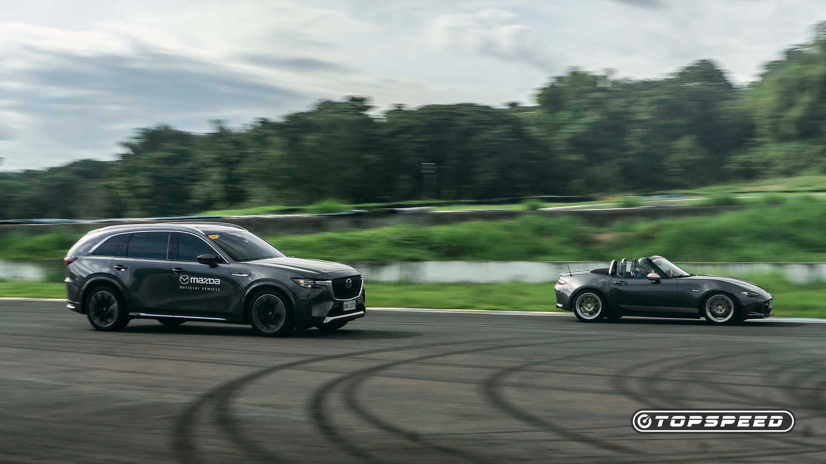 A 2021 Mazda MX-5 Miata and a CX-90 going around the track