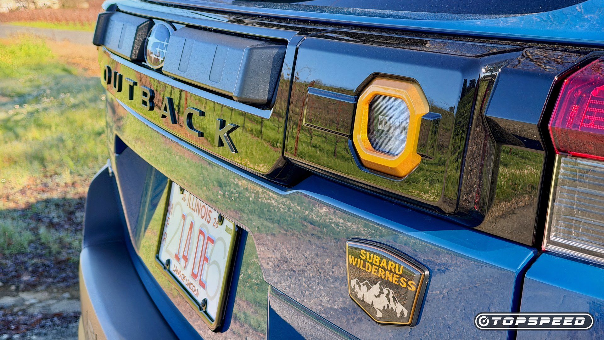 Rear three-quarter view highlighting the Wilderness body graphics